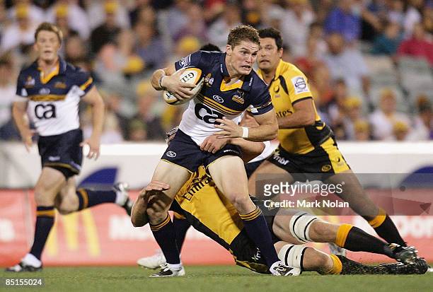 Josh Holmes of the Brumbies is tackled during the round three Super 14 match between the Brumbies and the Western Force at Canberra Stadium on...