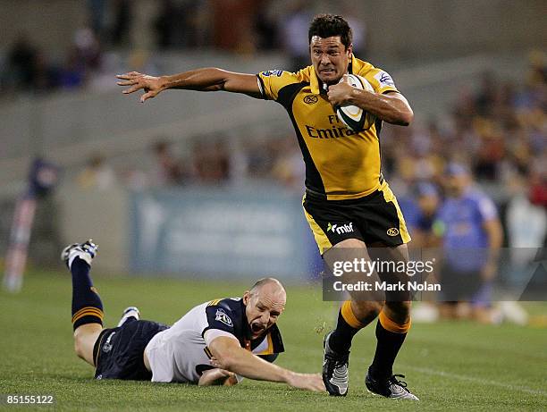 Cameron Shepherd of the Force beats the tackle of Stirling Mortlock of the Brumbies during the round three Super 14 match between the Brumbies and...