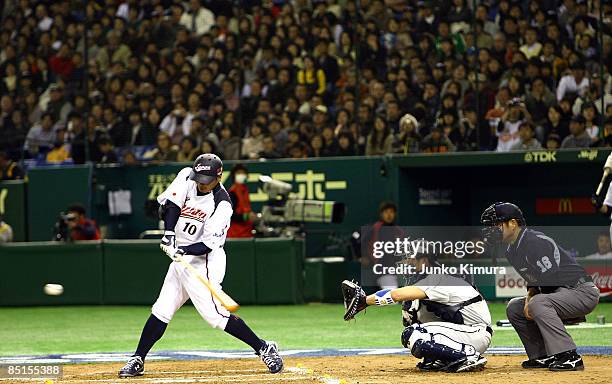 Chatcher Shinnosuke Abe of Japan bats during a friendly match between Japan and Saitama Seibu Lions at Tokyo Dome on February 28, 2009 in Tokyo,...