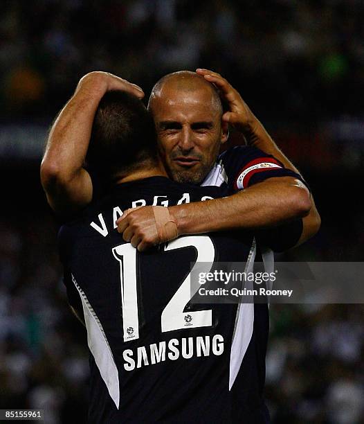 Kevin Muscat of the Victory embraces team mate Rodrigo Vargas following the A-League Grand Final match between the Melbourne Victory and Adelaide...