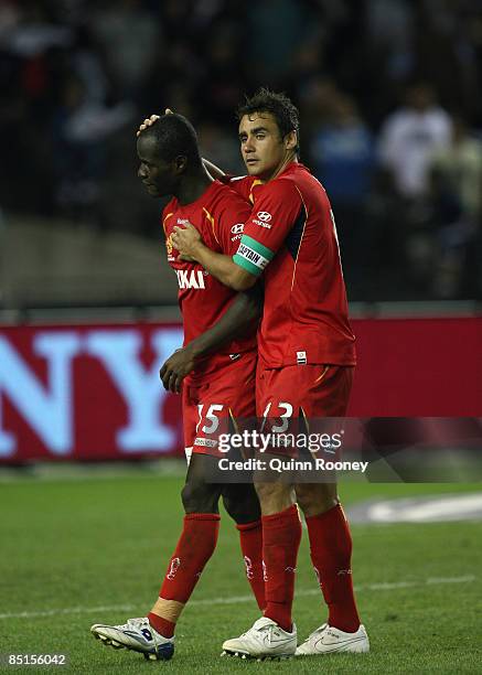 Travis Dodd of United consoles Gyawe Jonas Salley of United following defeat in the A-League Grand Final match between the Melbourne Victory and...