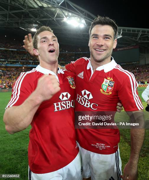 British and Irish Lions' George North and Mike Phillips celebrate on the pitch following the game