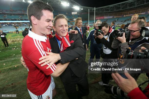 British and Irish Lions' Jonathan Sexton celebrates with actor Daniel Craig, after the game