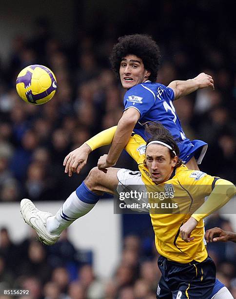 Everton's Belgian midfielder Marouane Fellaini competes with West Bromwich Albion's English midfielder Jonathan Greening during their English Premier...