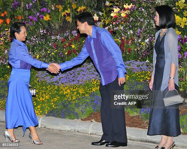 Philippine President Gloria Arroyo is greeted by Thai Prime Minister Abhisit Vejjajiva and his wife Pimpen as she arrives for the gala dinner for...