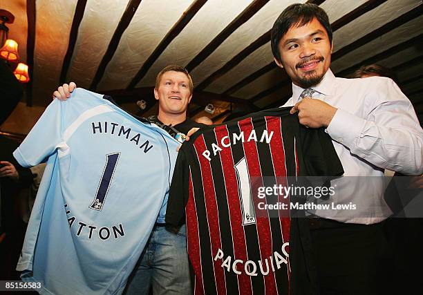 Ricky Hatton and Manny Pacquiao are presented with Manchester City shirts after the darts match to promote their 'World Junior Welterweight...