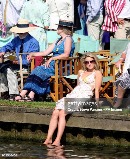 Women cools her feet off in the river during day four of the Royal Henley Regatta, Henley on Thames.