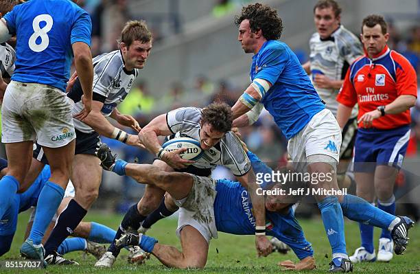Thom Evans of Scotland is tackled by Paul Griffen of Italy during the RBS Six Nations Championship match between Scotland and Italy at the...