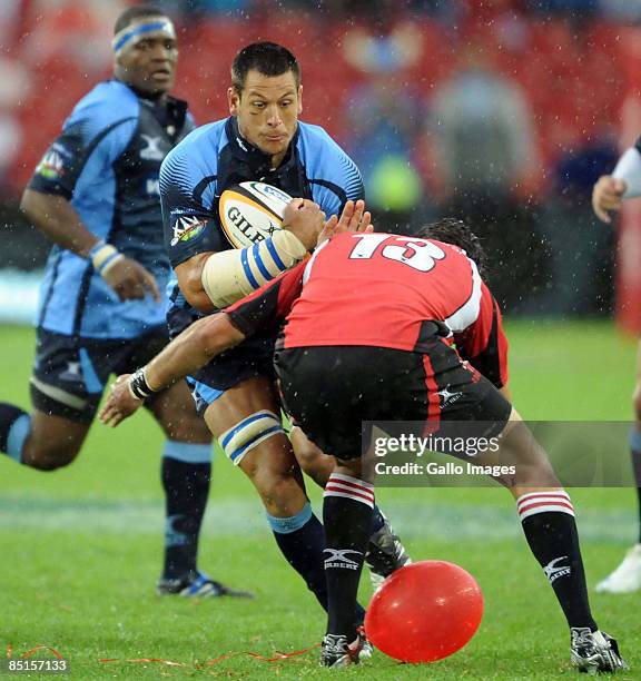 Pierre Spies of the Bulls is tackled by Jaques Fourie during the round three Super 14 match between the Lions and Bulls at Coca-Cola Park on February...