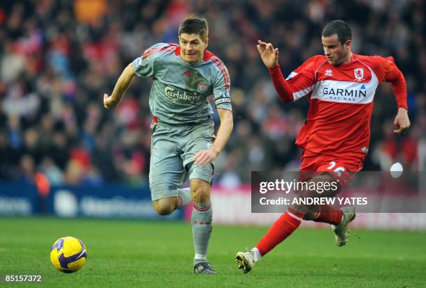 Liverpool's English midfielder Steven Gerrard vies with Middlesbrough's English defender Matthew Bates during their English Premier league football...