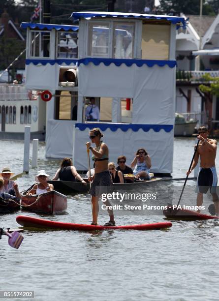 People paddle on the water during day five of the Royal Henley Regatta, Henley on Thames.