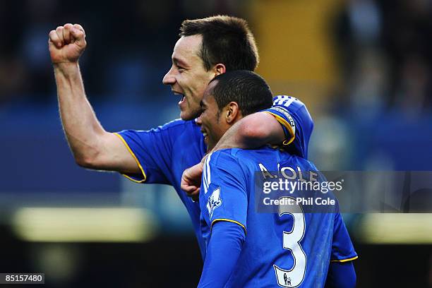 John Terry of Chelsea celebrates with team mate Ashley Cole following the Barclays Premier League match between Chelsea and Wigan Athletic at...