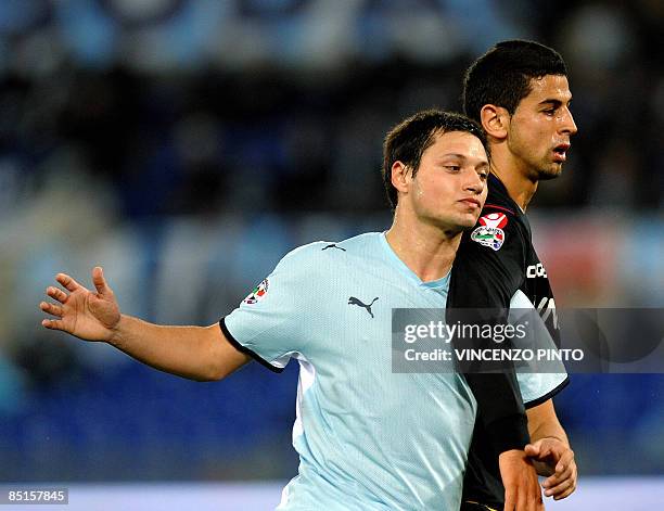 Bologna's defender Miguel Angel Britos of Uruguay tries to stop Lazio's Argentine forward Mauro Matias Zarate during their Serie A football match at...