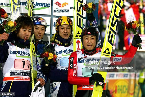 The Japanese team of Shohei Tochimoto, Takanobu Okabe, Daiki Ito and Noriaki Kasai celebrate winning the bronze medal during the Men's Team Ski...