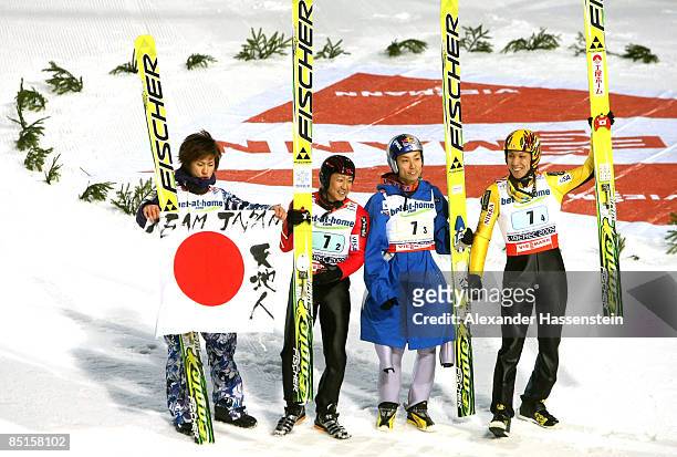 The Japanese team of Shohei Tochimoto, Takanobu Okabe, Daiki Ito and Noriaki Kasai celebrate winning the bronze medal during the Men's Team Ski...