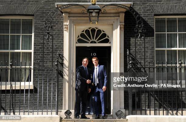 Prime Minister David Cameron greets Wimbledon winner Andy Murray outside 10 Downing Street before attending a cross-party reception in the garden,...