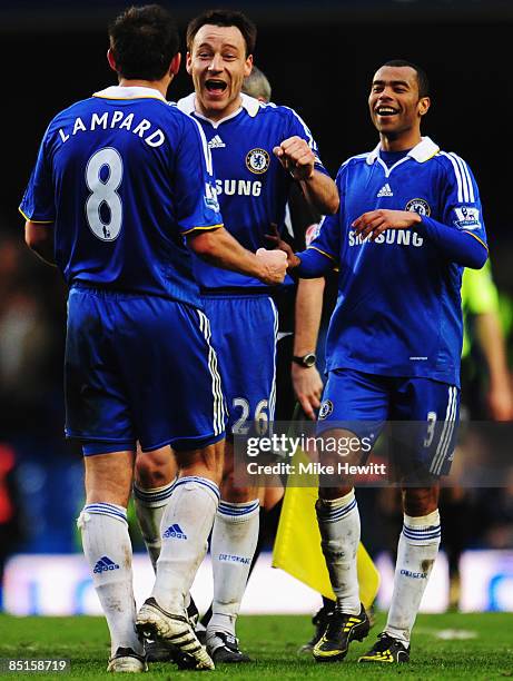 John Terry of Chelsea celebrates with team mates Ashley Cole and Frank Lampard following the Barclays Premier League match between Chelsea and Wigan...
