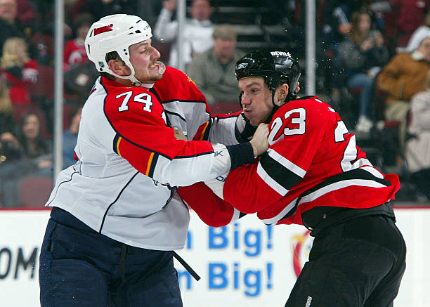 David Clarkson of the New Jersey Devils trades punches with Nick Tarnasky the Florida Panthers at the Prudential Center on February 28, 2009 in...