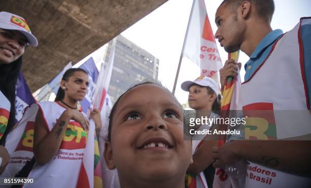 Child gestures during a demonstration organised by the Central of Brazil's Workers and the other trade union centrals with demonstrators carrying...