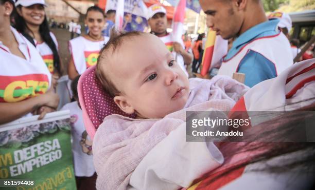 Woman holds a baby during a demonstration organised by the Central of Brazil's Workers and the other trade union centrals with demonstrators carrying...