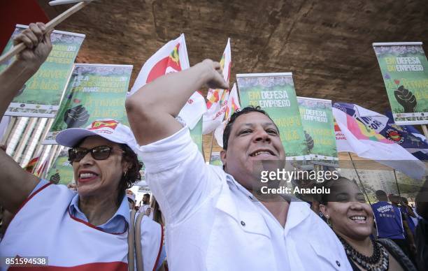 People hold banners during a demonstration organised by the Central of Brazil's Workers and the other trade union centrals with demonstrators...