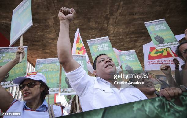 People hold banners during a demonstration organised by the Central of Brazil's Workers and the other trade union centrals with demonstrators...