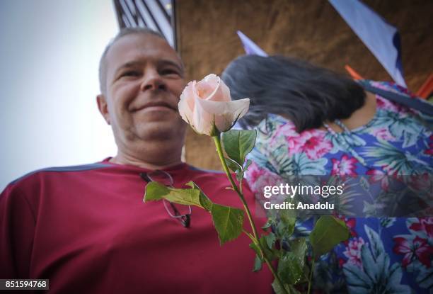 Woman receives a flower during a demonstration organised by the Central of Brazil's Workers and the other trade union centrals with demonstrators...