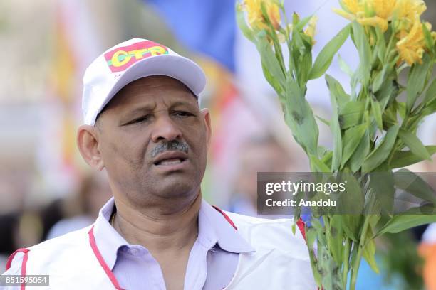 Man holds flowers during a demonstration organised by the Central of Brazil's Workers and the other trade union centrals with demonstrators carrying...