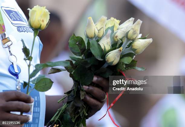 Man holds flowers during a demonstration organised by the Central of Brazil's Workers and the other trade union centrals with demonstrators carrying...