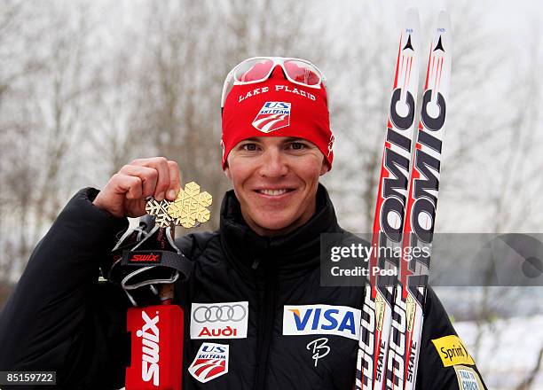 Bill Demong of USA poses with a medal from a previous event and the Gold medal won during the Nordic Combined Individual II Event at the FIS Nordic...