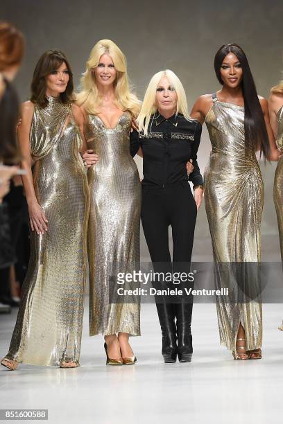 Carla Bruni, Claudia Schiffer, Donatella Versace and Naomi Campbell walk the runway at the Versace show during Milan Fashion Week Spring/Summer 2018...