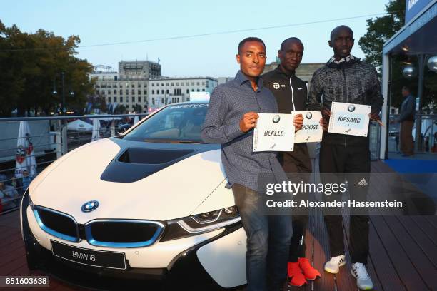 Kenenisa Bekele of Ethiopia, Eliud Kipchoge of Kenya and Wilson Kipsang of Kenya pose with their starting numbers for the BMW Berlin Marathon 2017 on...