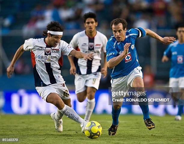 Gabriel Pereyra of Atlante vies for the ball with Gerardo Torrado of Cruz Azul during their 2009 Mexican Clausura Tournament football match at the...