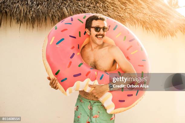 tourist at the beach - donut man stock pictures, royalty-free photos & images