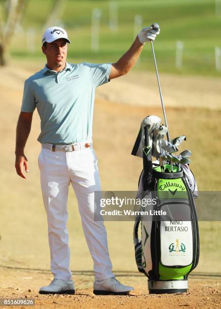 Nino Bertasio of Italy takes an iron from his bag on the 3rd hole during day two of the Portugal Masters at Dom Pedro Victoria Golf Club on September...