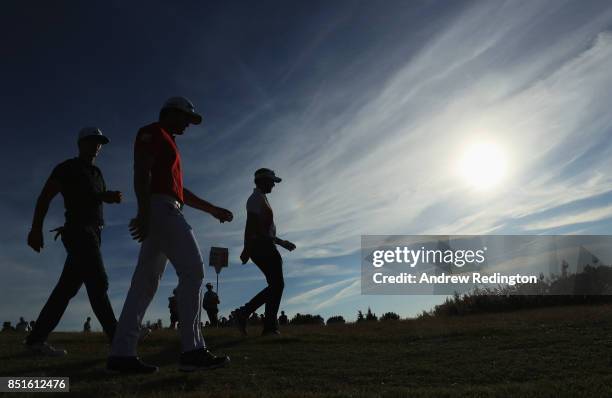 Thorbjorn Olesen of Denmark, Ricardo Gouveia of Portugal and Joost Luiten of the Netherlands walk down a fairway during day two of the Portugal...