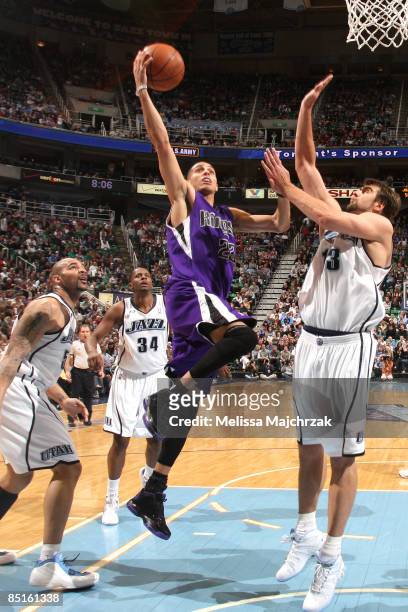 Kevin Martin of the Sacramento Kings goes for the shot over Mehmet Okur of the Utah Jazz at EnergySolutions Arena on February 28, 2009 in Salt Lake...