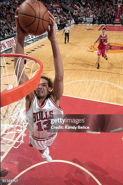 Joakim Noah of the Chicago Bulls goes for a dunk during the NBA game against the Houston Rockets on February 28, 2009 at the United Center in...