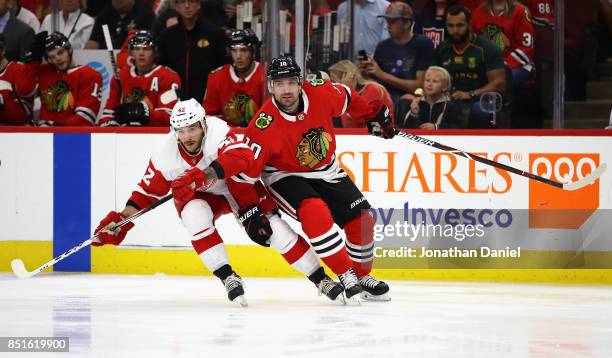 Patrick Sharp of the Chicago Blackhawks battles for position with Martin Frk of the Detroit Red Wings during a preseason game at the United Center on...