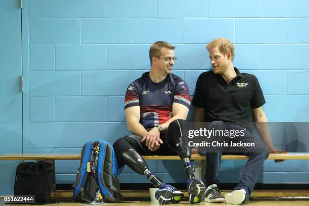 Prince Harry sits with Charlie Walker Of the UK armed forces team during a pre Invictus Games training session at Pan Am Sports Centre on September...