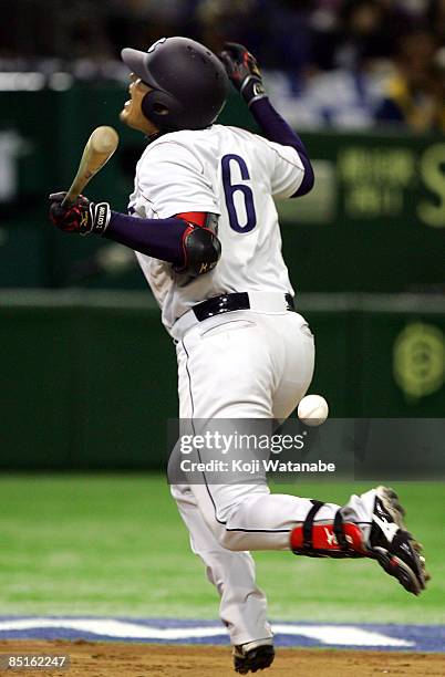 Outfielder Taketoshi Gotoh of Saitama Seibu Lions is hit by a pitch during a friendly match between China and Saitama Seibu Lions at Tokyo Dome on...