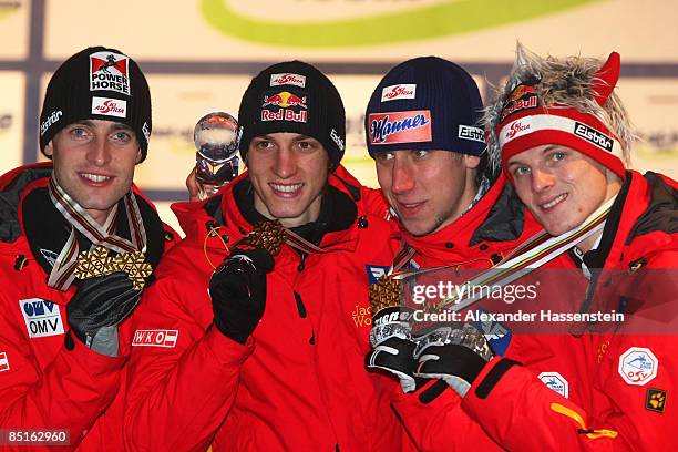 The team from Austria pose with the Gold medals won during the Men's Team Ski Jumping 134M Hill competition at FIS Nordic World Ski Championships...