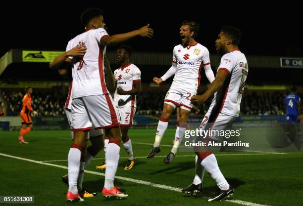 Alex Gilbey of MK Dons celebrates with team mates after Ryan Seagen of MK Dons scores his sides first goal during the Sky Bet League One match...