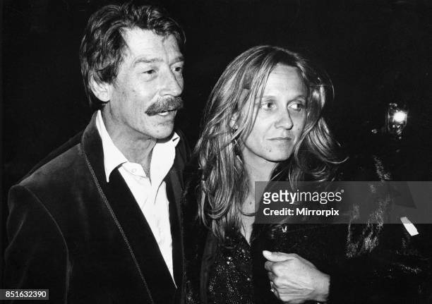 British actor John Hurt arrives at the Royal Albert Hall in London with his wife Donna to attend the musical 'The Hunting of the Snark' based on...