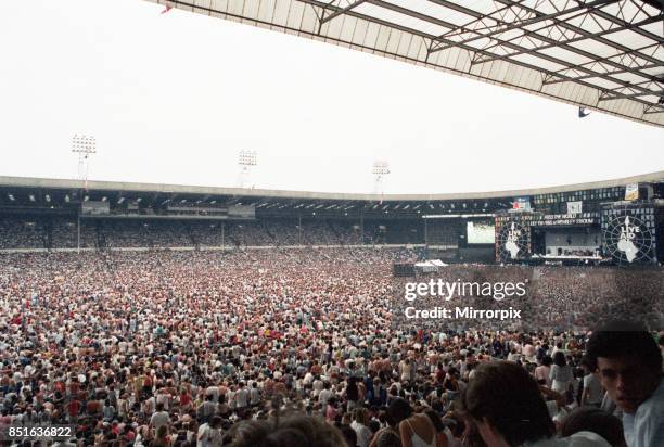 Live Aid concert held at Wembley Stadium, London to raise funds for relief of the ongoing Ethiopian famine. View of the huge crowd of around 72,000...