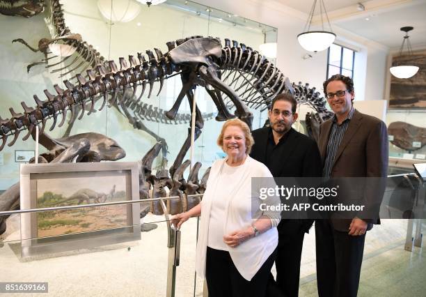 Rhoda Knight Kalt, composer John Musto and librettist Eric Einhorn pose for a picture during an interview at the Dinosaur Hall of the American Museum...