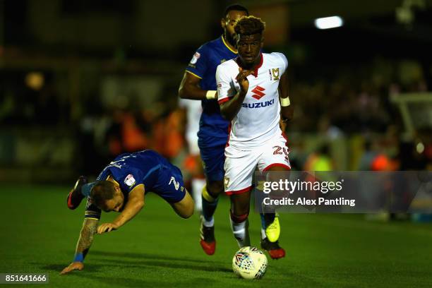 Aaron Tshibola of MK Dons takes on Barry Fuller of AFC Wimbledon during the Sky Bet League One match between A.F.C. Wimbledon and Milton Keynes Dons...