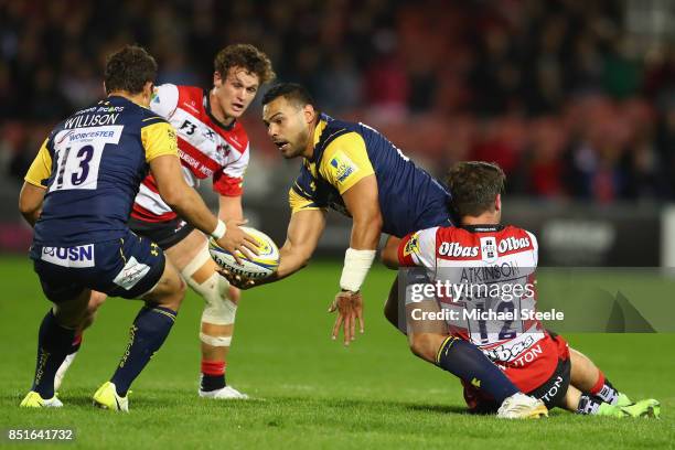 Ben Te'o of Worcester Warriors feeds a pass to Jackson Willison as Mark Atkinson of Gloucester holds on during the Aviva Premiership match between...