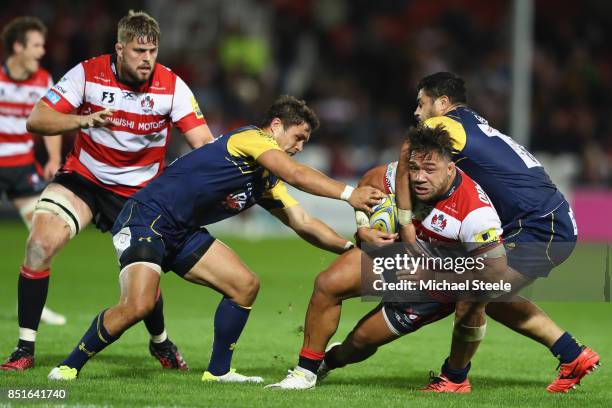 Motu Mati'u of Gloucester is tackled by Alafoti Faosiliva and Jackson Willison of Worcester Warriors during the Aviva Premiership match between...