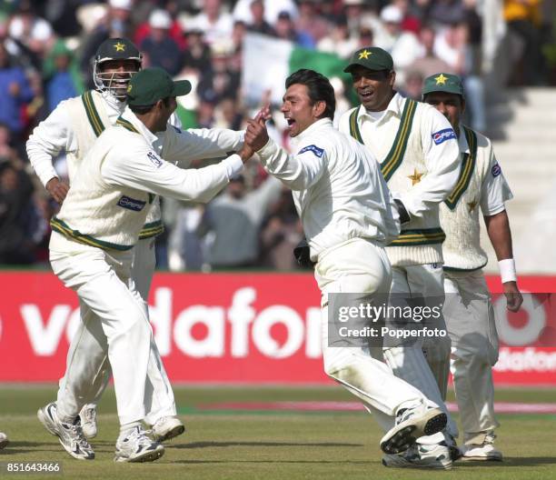 Saqlain Mushtaq of Pakistan celebrates with his team mates after bowling Andrew Caddick of England during the Second npower Test match between...